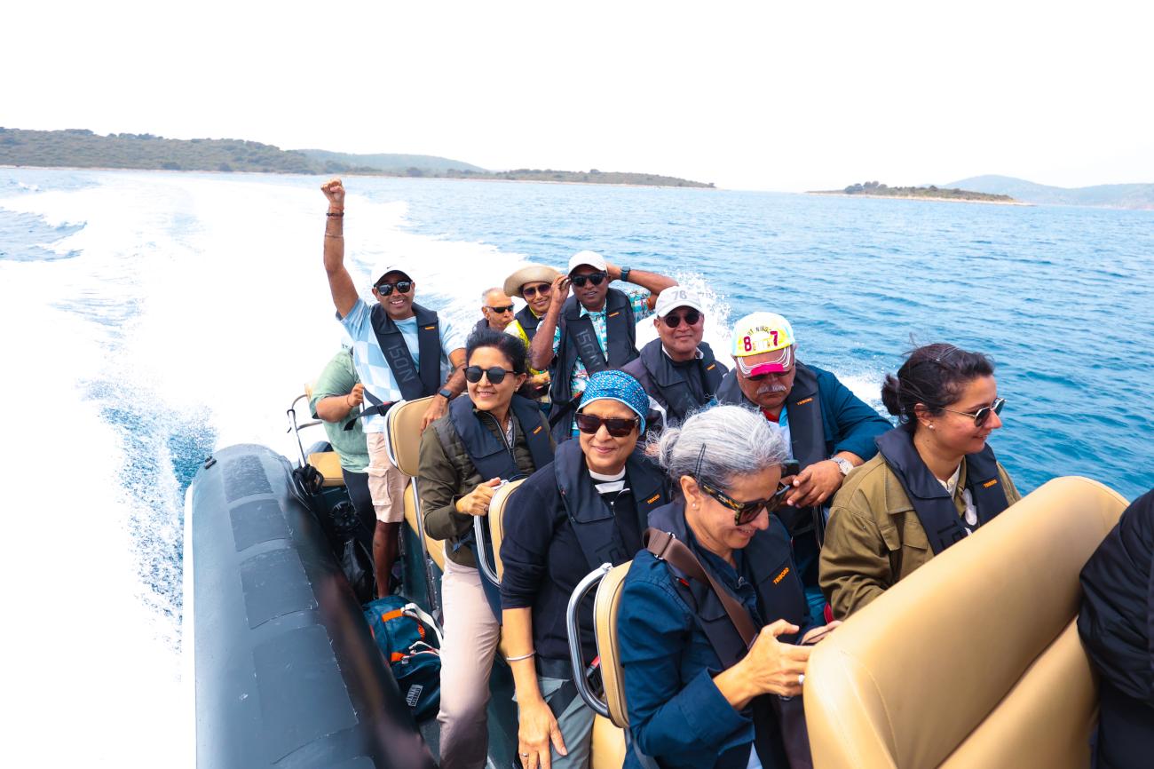 Tour group enjoying a speedboat ride across the turquoise Adriatic Sea near Croatian islands
