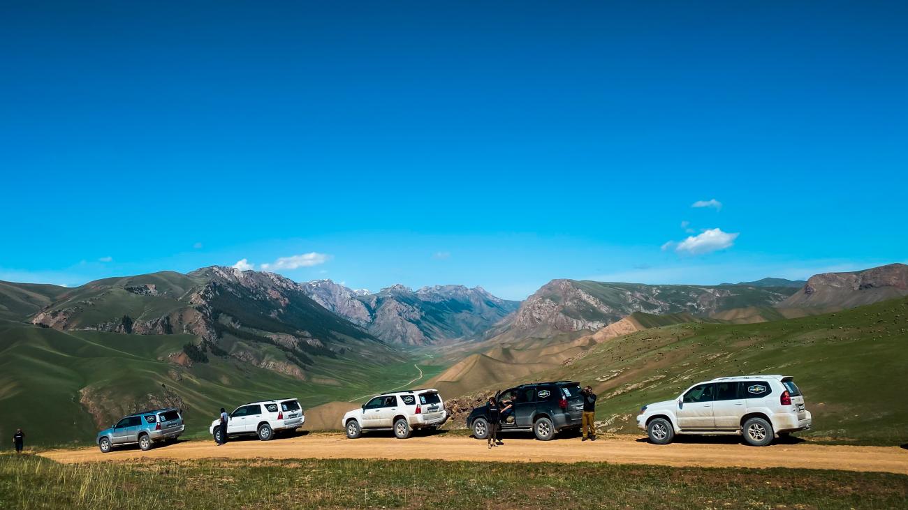 Toyota Sequoia convoy at mountain pass panorama Kyrgyzstan