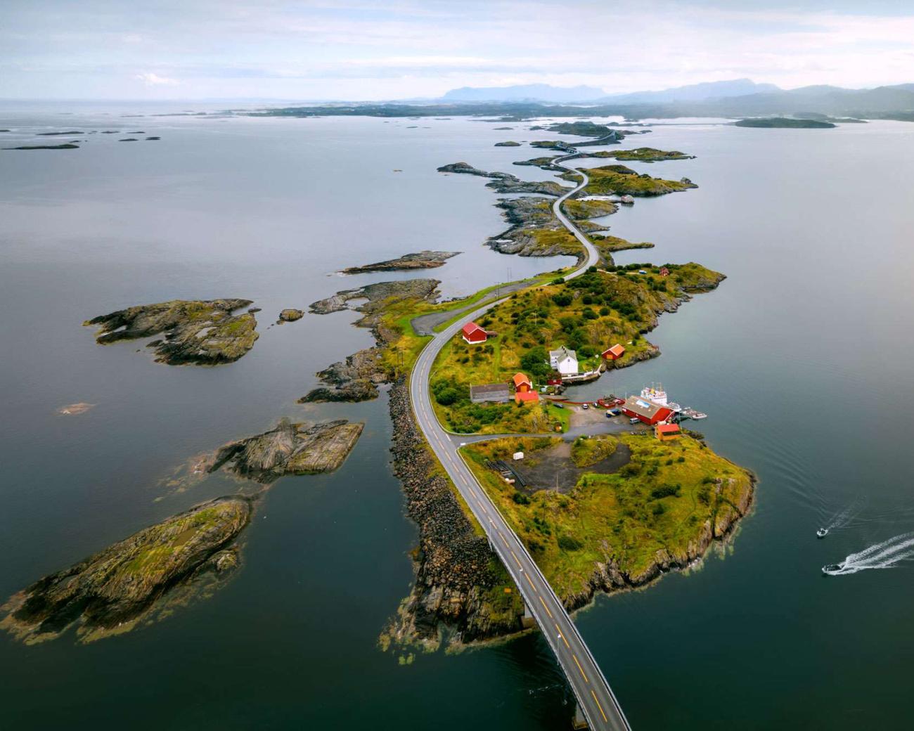 Aerial view of the Atlantic Ocean Road winding across small islands with red-roofed houses along the Norwegian coast.