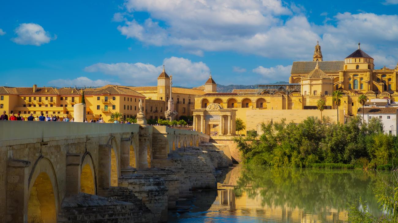 The Roman Bridge spanning the Guadalquivir River with the Mezquita-Cathedral rising behind it in Cordoba.